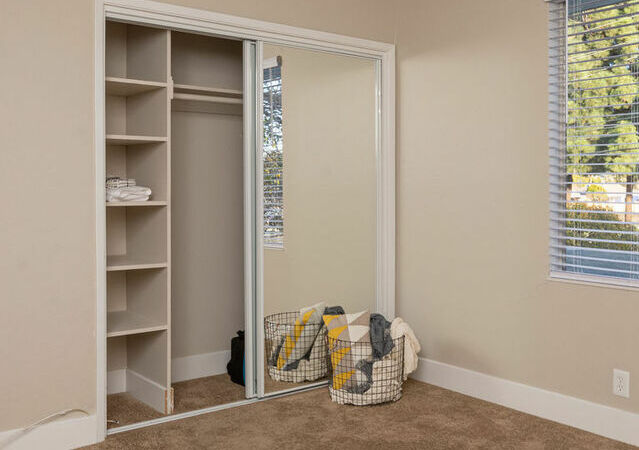 Apartments in Hayward CA - Jackson Flats Spacious Bedroom with Large Window and Sliding Mirror Closet Door