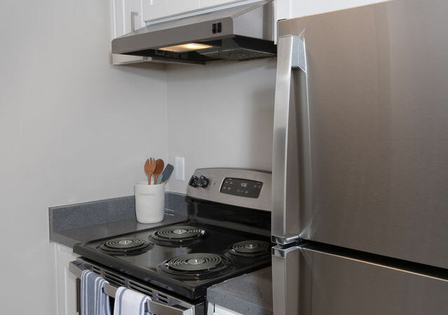Apartments for Rent Hayward CA - Jackson Flats - Kitchen with Stainless Steel Appliances, White Cabinets, and Grey Countertops