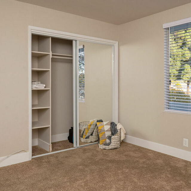 Apartments in Hayward CA - Jackson Flats Spacious Bedroom with Large Window and Sliding Mirror Closet Door
